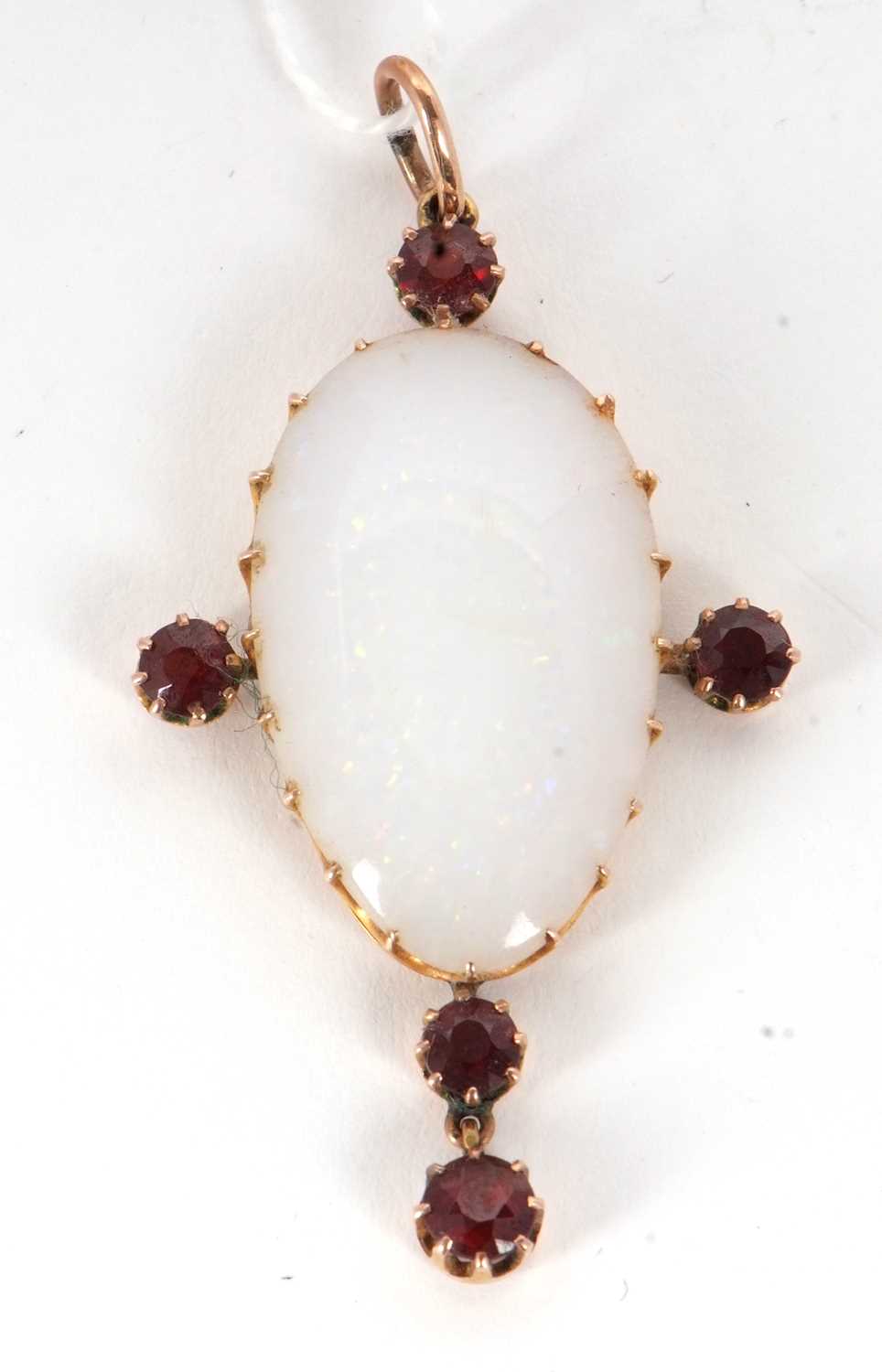 An opal and garnet pendant, the pear shape opal cabochon, claw mounted and set with four similarly - Image 2 of 3