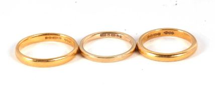 Three gold rings: one 22ct ring hallmarked London 1987, size K, 3.2g, a 22ct ring hallmarked