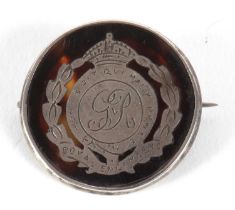 An early 20th century silver and tortoiseshell Royal Engineers badge, the round tortoiseshell