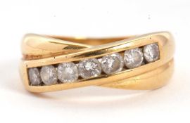 An 18ct diamond crossover ring, with a two strand crossover, one with channel set round brillinat