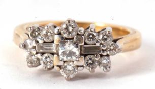 An 18ct diamond cluster ring, set to centre with a princess cut diamond and a baguette cut diamond