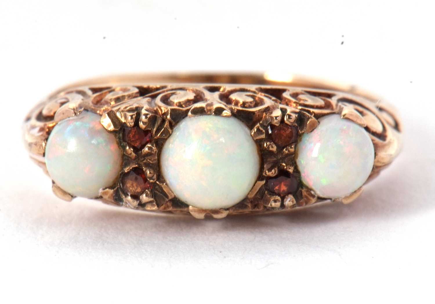 A 9ct opal and garnet ring, the three slightly graudated round opal cabochons, interspaced with - Image 7 of 7