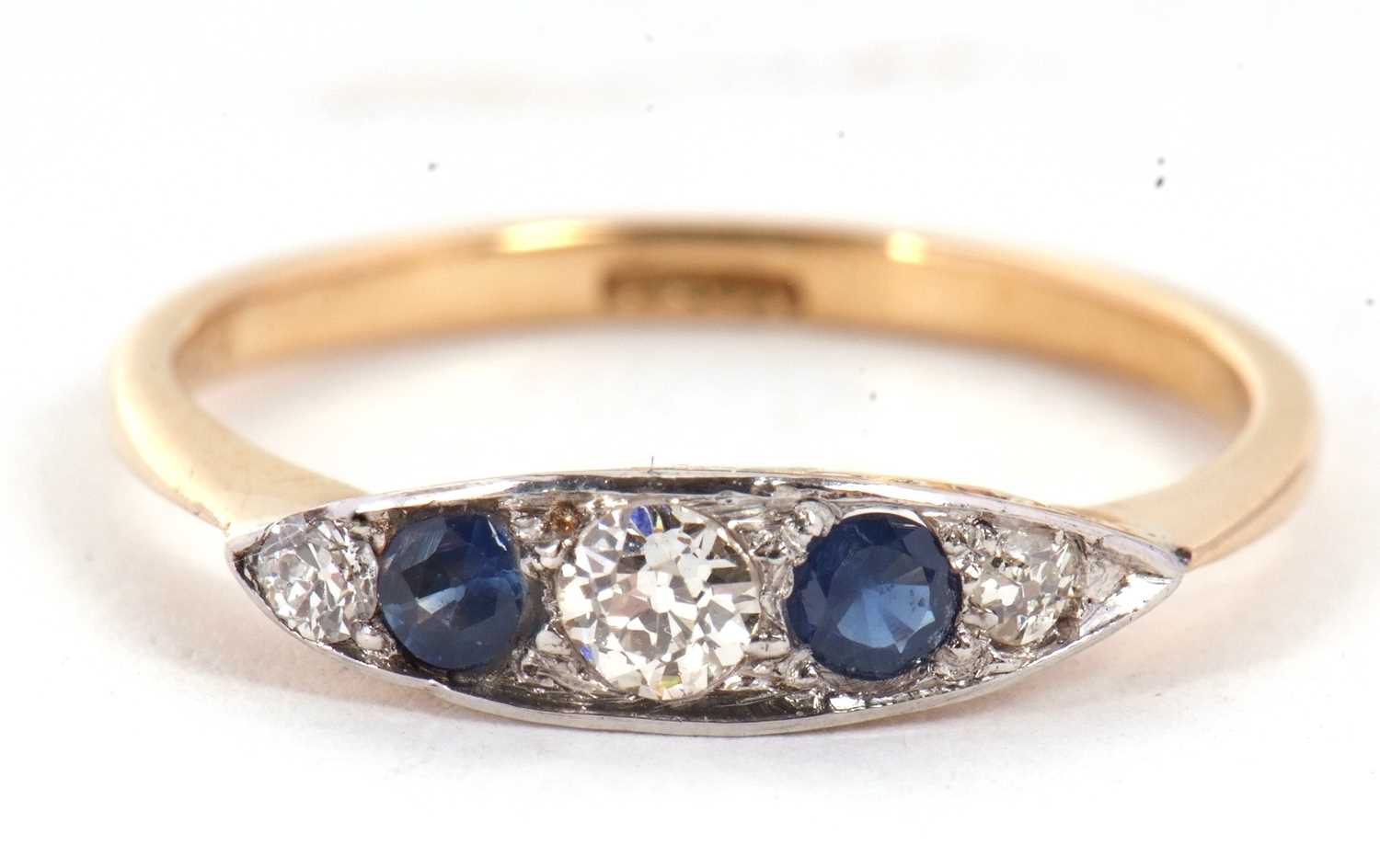 A sapphire and diamond ring, the marquise shape plaque set with alternating old mine cut diamonds