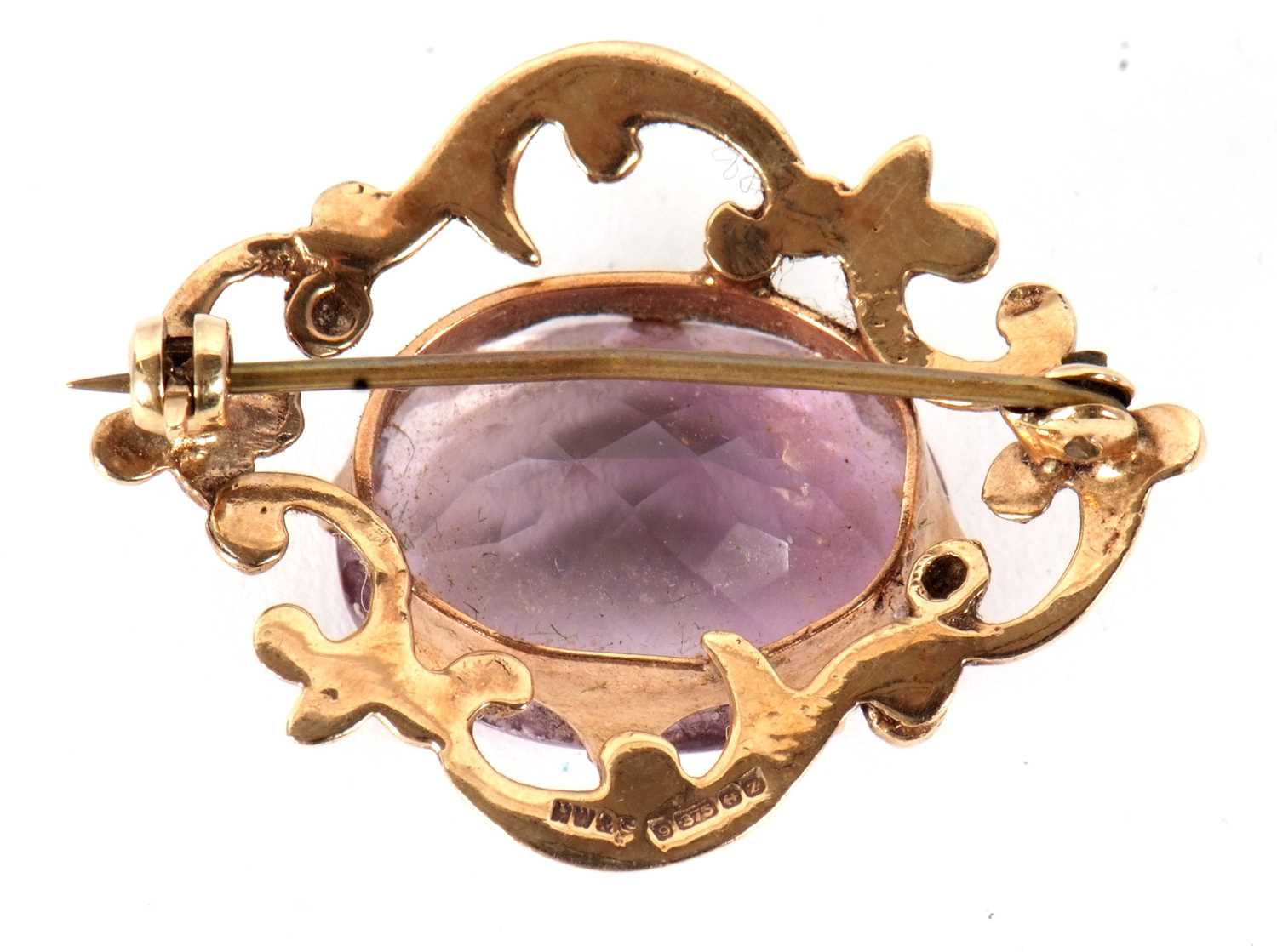 A 9ct amethyst brooch, the oval claw mounted amethyst, surrounded by a scrolled frame yellow gold, - Image 2 of 3