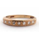 A 9ct diamond ring, the half hoop set with round single cut diamonds, slightly tapered shoulders and