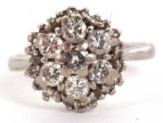 An 18ct diamond cluster ring, the round brilliant cut diamonds in a cluster formation surrounded