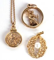 Two 9ct pendants and another pendant and chain, the first a St Christopher pendant hallmarked London