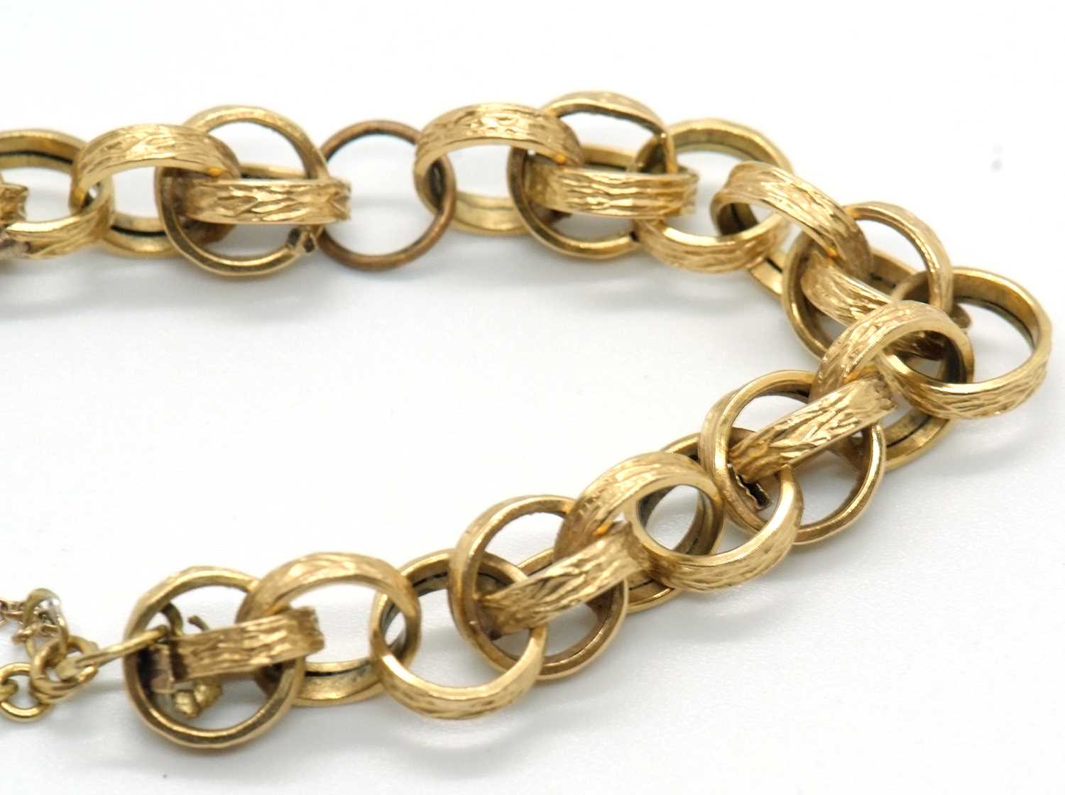 An 18ct fancy link bracelet, the textured round hooped links (test as approx. 18ct gold), with T-bar - Image 3 of 3