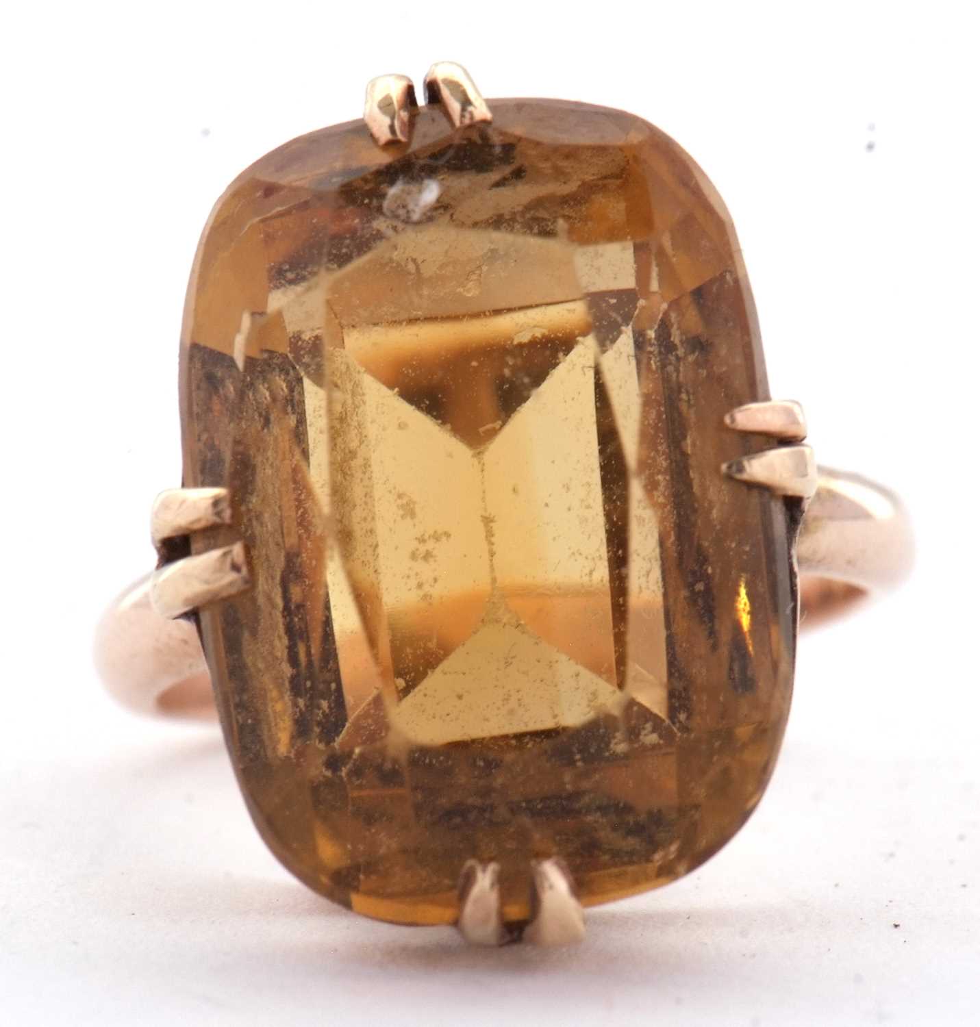 A 9ct citrine ring, the oval mixed cut citrine, approx. 19mm long, in four double claw mount with