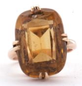 A 9ct citrine ring, the oval mixed cut citrine, approx. 19mm long, in four double claw mount with