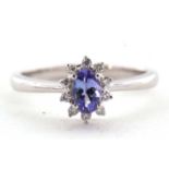 A platinum certified tanzanite and diamond ring, the oval claw mounted tanzanite, 0.36cts,