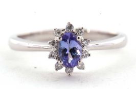 A platinum certified tanzanite and diamond ring, the oval claw mounted tanzanite, 0.36cts,