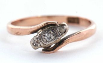 A 9ct diamond ring, the three small round diamonds, illusion mounted in a crossover band of rose
