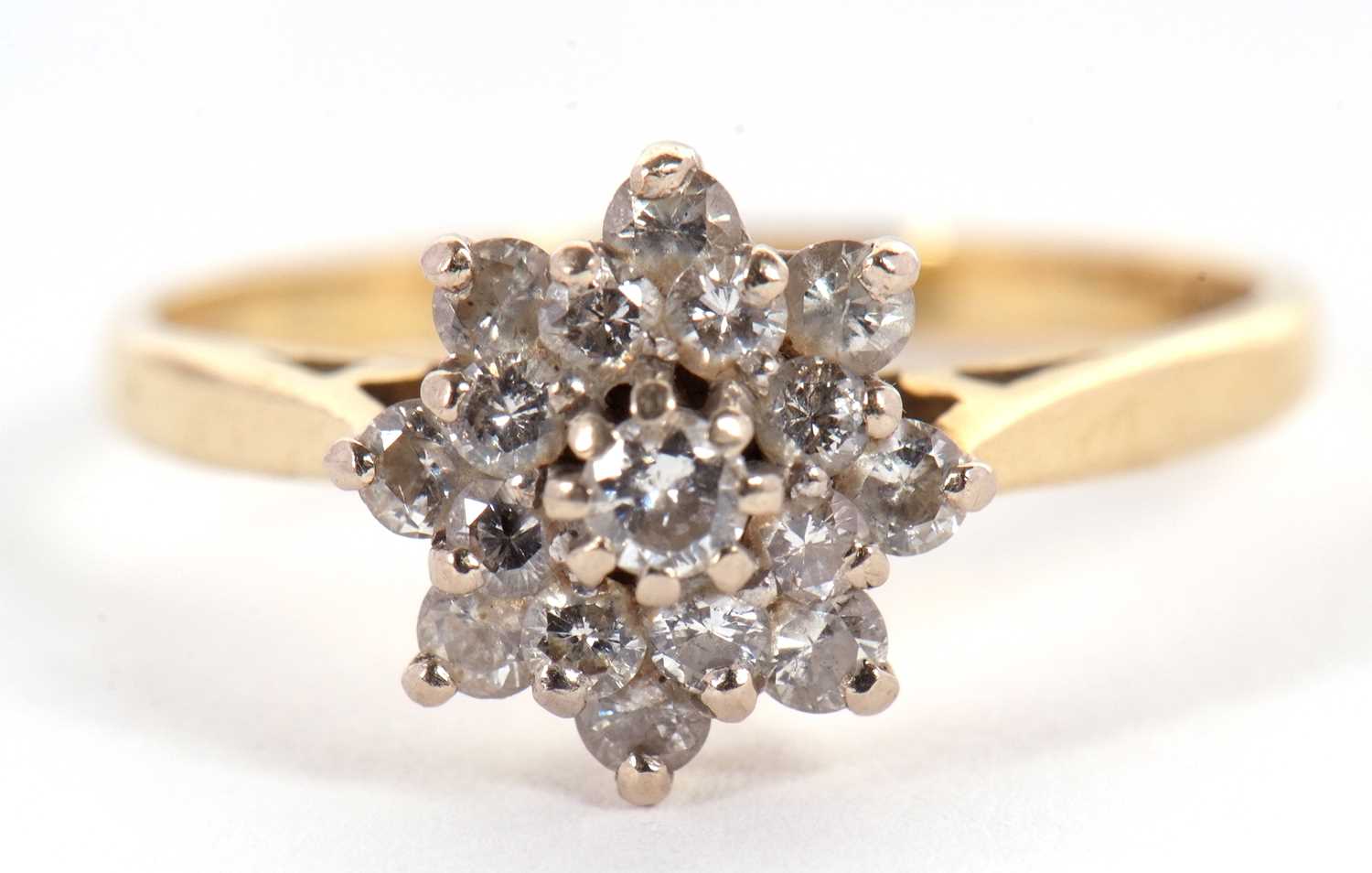 An 18ct diamond cluster ring, the central round brilliant cut diamond surrounded by a further 8