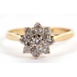 An 18ct diamond cluster ring, the central round brilliant cut diamond surrounded by a further 8