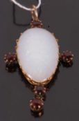 An opal and garnet pendant, the pear shape opal cabochon, claw mounted and set with four similarly