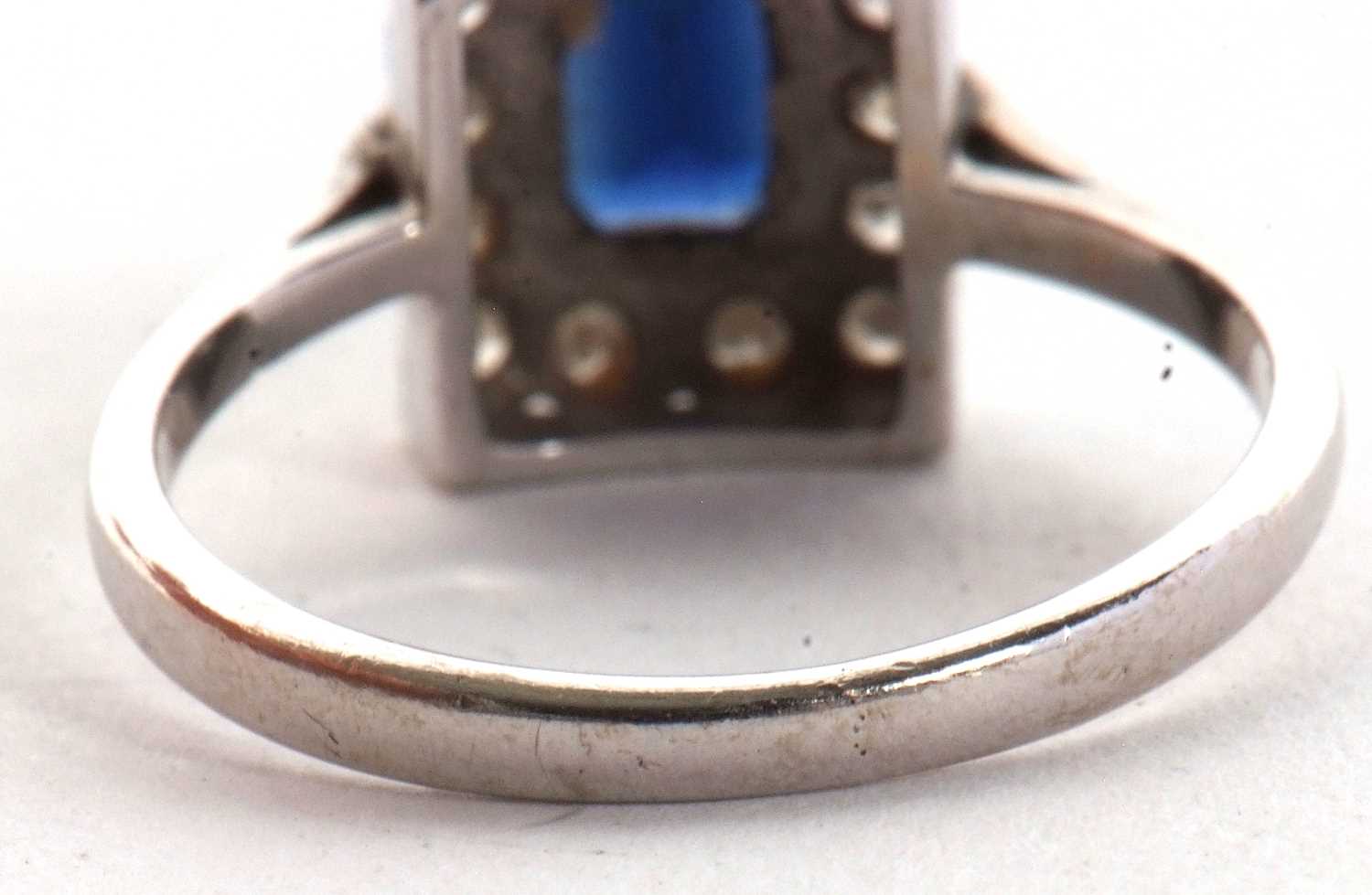 An 18ct sapphire and diamond ring, the rectangular step cut sapphire, surrounded by single cut - Image 2 of 6
