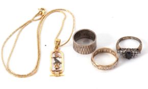 An Egyptian necklace and three rings, the Egyptian pendant set with hieroglyphs and Egyptian