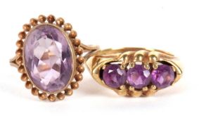 Two amethyst rings, the first an oval collet mounted amethyst with rope twist border, split