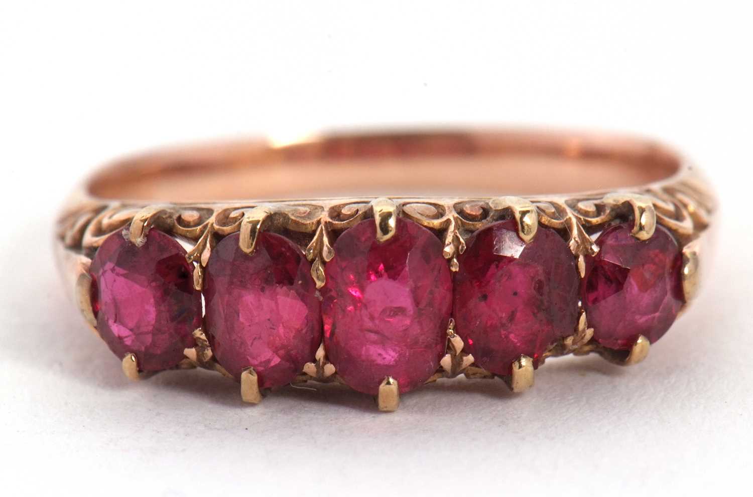 A five stone ruby ring, the five graduated rubies all claw mounted with a scrolled gallery and - Image 2 of 7