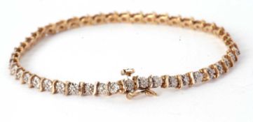 A 9ct diamond bracelet, the small illusion set diamonds in white gold, separated by small blades
