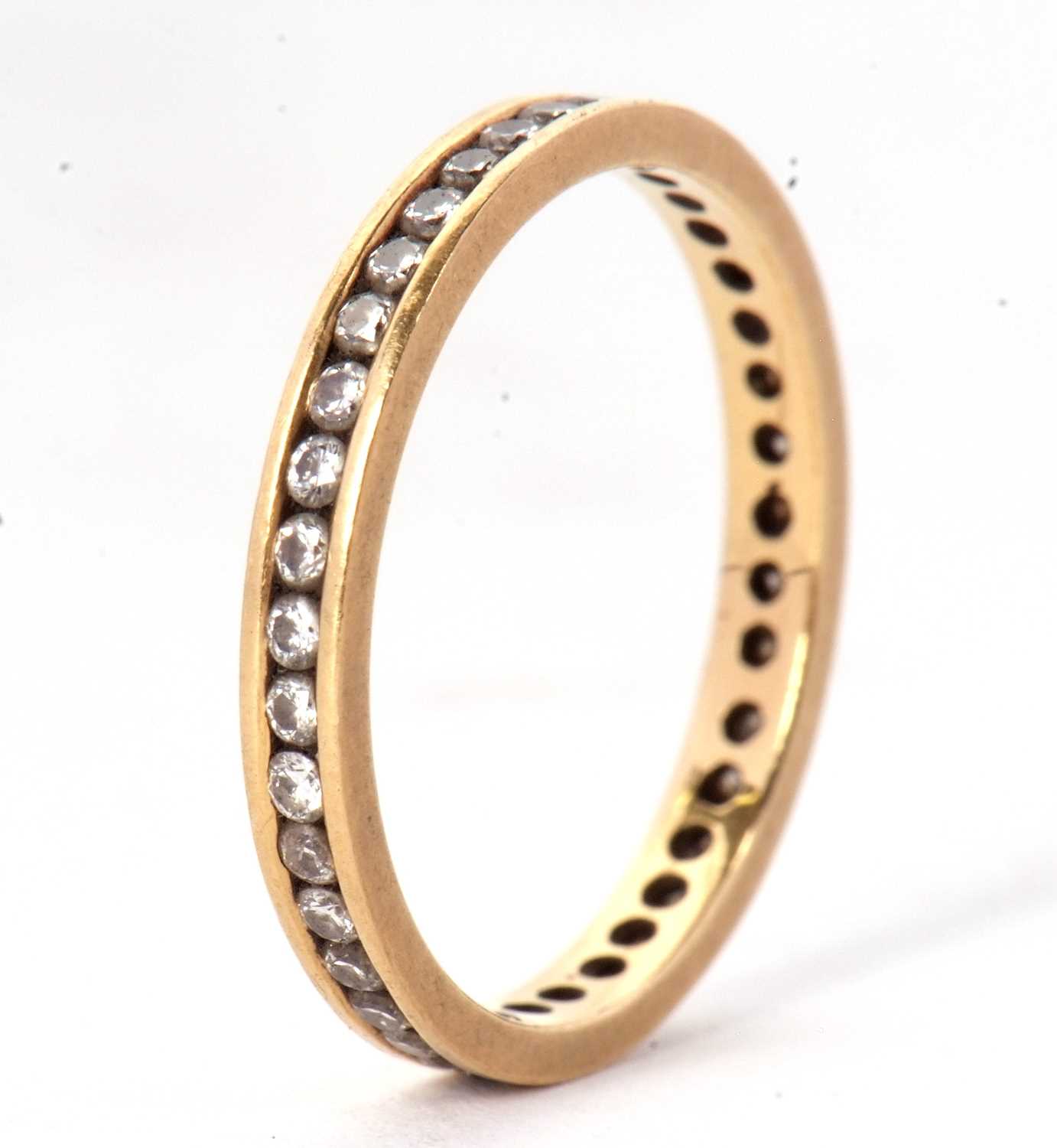 An 18ct eternity ring, with channel set small round diamonds, total estimated approx. 0.50cts, - Image 3 of 3