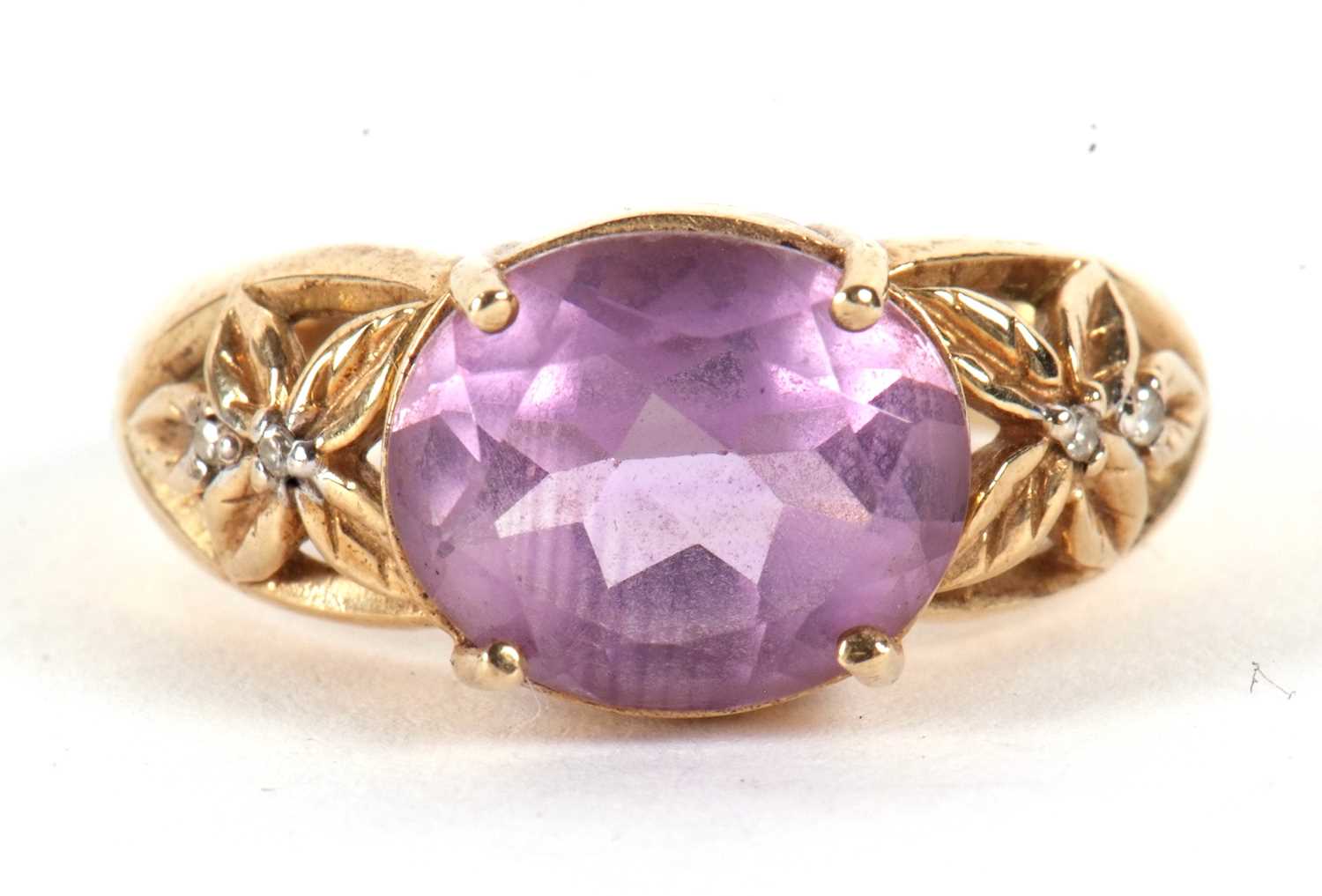 A 9ct amethyst ring, the oval amethyst in a four claw mount, with tapered pierced shoulders set with