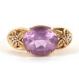A 9ct amethyst ring, the oval amethyst in a four claw mount, with tapered pierced shoulders set with