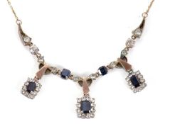 A sapphire and white stone necklace, the three rectangular deep blue sapphires, surrounded by