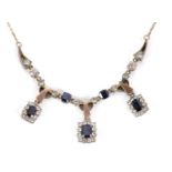 A sapphire and white stone necklace, the three rectangular deep blue sapphires, surrounded by