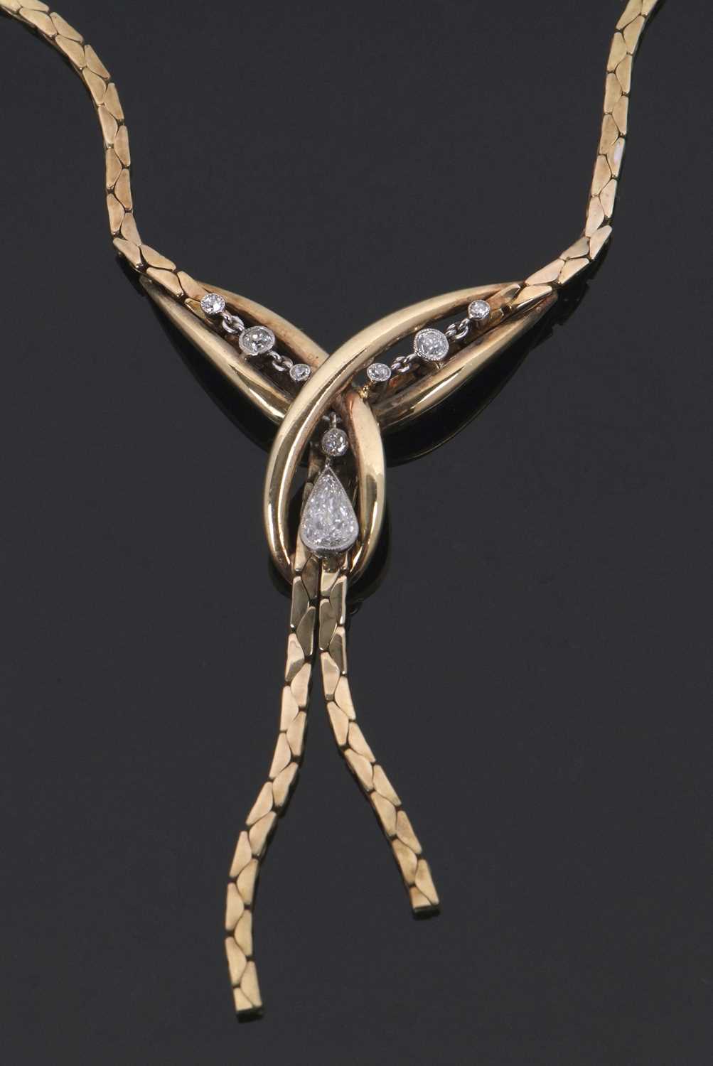 A 9ct diamond necklace, set to centre with crossover loop of gold set with a pear shape and a