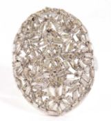 A diamond plaque ring, the oval plaque set with a mix of tapered baguette cut diamonds, totalling
