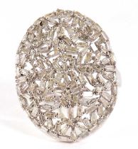 A diamond plaque ring, the oval plaque set with a mix of tapered baguette cut diamonds, totalling