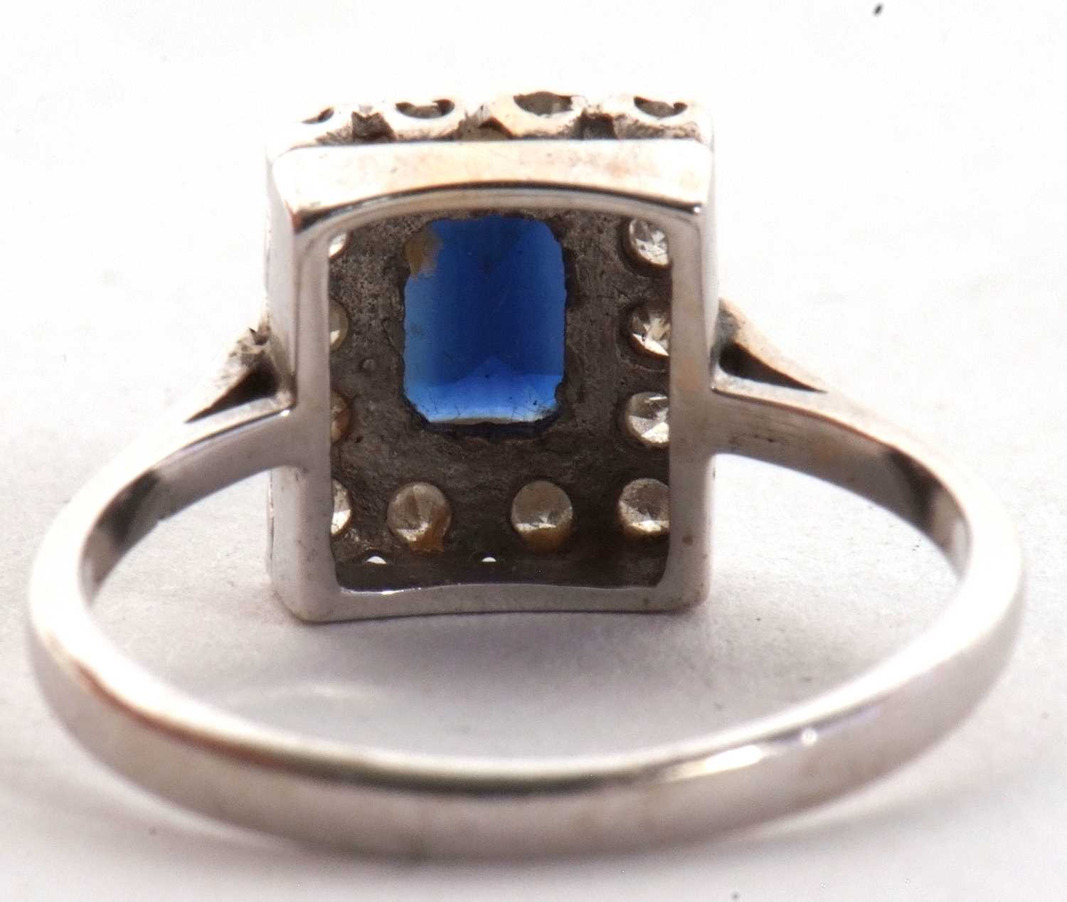 An 18ct sapphire and diamond ring, the rectangular step cut sapphire, surrounded by single cut - Image 4 of 6