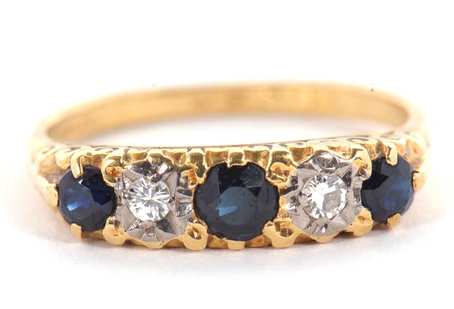 An 18ct sapphire and diamond ring, the three round sapphires interspaced with gypsy set round - Image 2 of 4