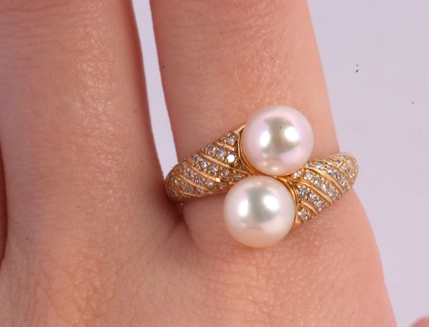 An 18ct cultured pearl and diamond crossover ring, the two cultured pearls set to a half set diamond - Image 3 of 8