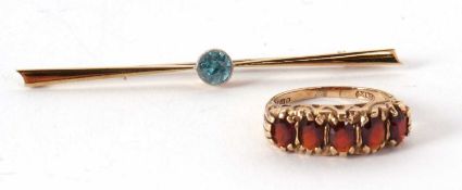 A 9ct ring and a 15ct bar brooch, the five stone garnet ring, claw mounted with scrolled gallery and