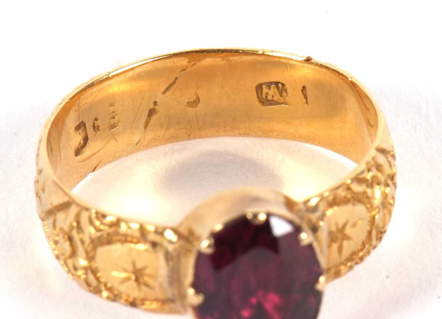 A garnet ring, the oval collet and claw mounted garnet with closed back, with 5.4mm wide band with - Image 4 of 6