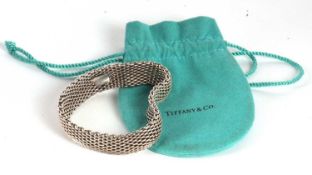 A Tiffany silver bracelet, the 5.5mm wide bracelet with fixed tag in inner band 'Tiffany & Co. 925',