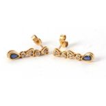 A pair of 18ct sapphire and diamond earrings, the collet mounted pear shape sapphire, suspended from