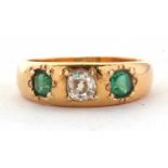 An emerald and diamond ring, the old mine cut diamond, estimated approx. 0.42cts, set to either side