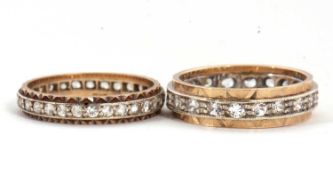 Two eternity rings, one with a central channel of white stones set in white metal with an outer band