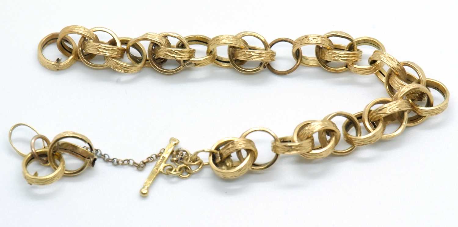 An 18ct fancy link bracelet, the textured round hooped links (test as approx. 18ct gold), with T-bar - Image 2 of 3