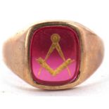 A 9ct Masonic ring, the red glass panel with gilt Masonic symbol inlay, 14mm wide, with tapered