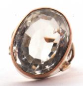 A citrine ring, the oval mixed cut citrine in a deep collet mount, with split shoulders and plain