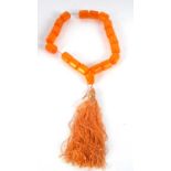 A faux amber bead necklace, the barrel shape beads, approx. 25mm diameter, approx. 55cmlong, with