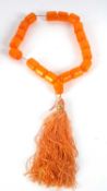 A faux amber bead necklace, the barrel shape beads, approx. 25mm diameter, approx. 55cmlong, with