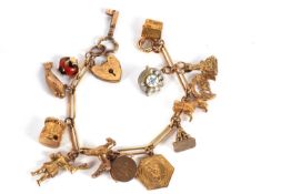 A fancy link charm bracelet, with heart shape padlock clasp stamped 9c and a quantity of charms