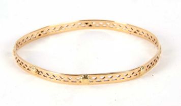 A bangle stamped 750, the 5mm wide pierced bangle with raised bead design, stamped 750, inner