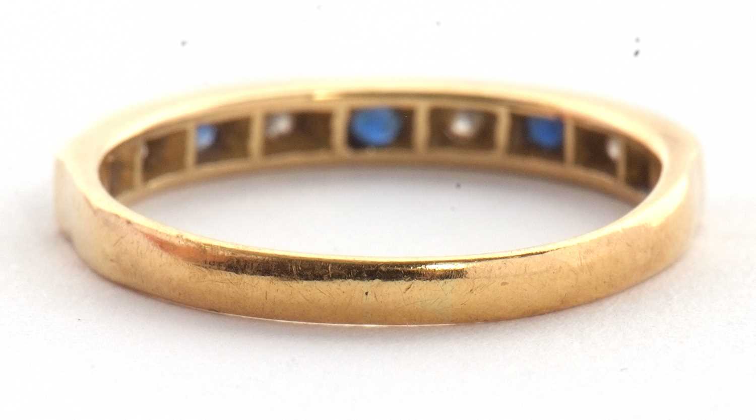 An 18ct sapphire and diamond ring, the half hoop ring set with alternating round sapphires and - Image 5 of 5